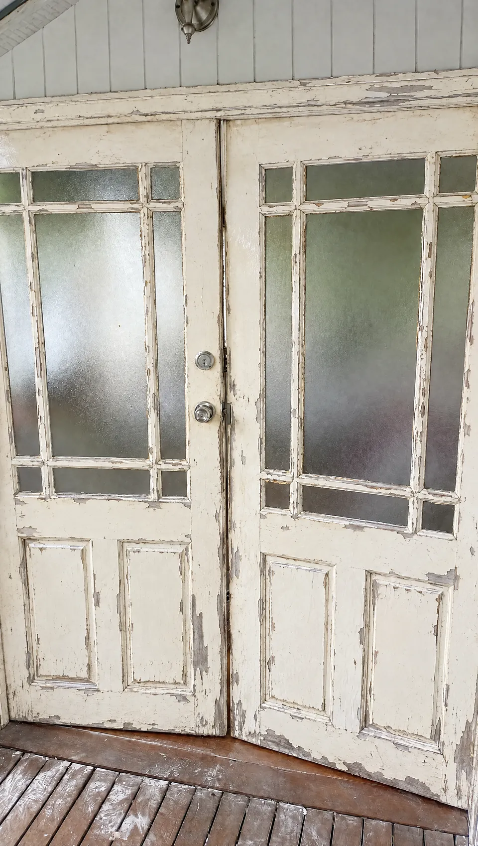 Before: weathered French doors with flaking paint