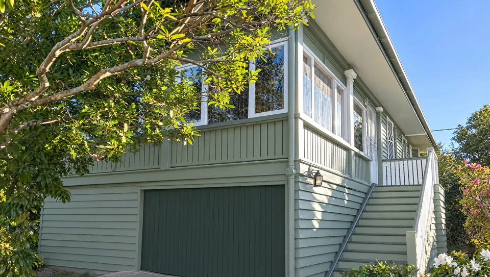 Weatherboard Queenslander, sage and white